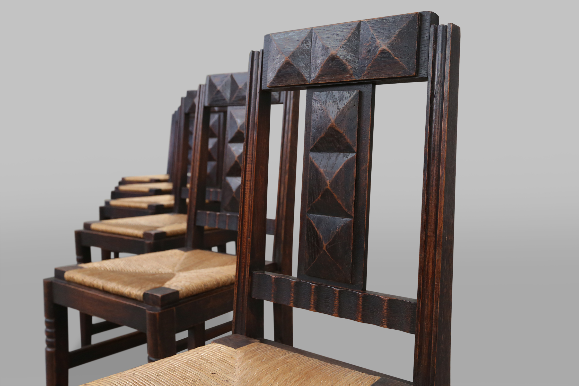 set of oak and wicker dining chairs by Victor Courtray
